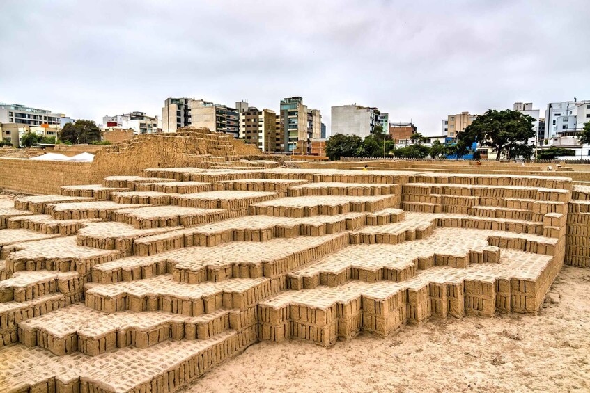 A large, stepped terracotta structure in an urban setting. 4