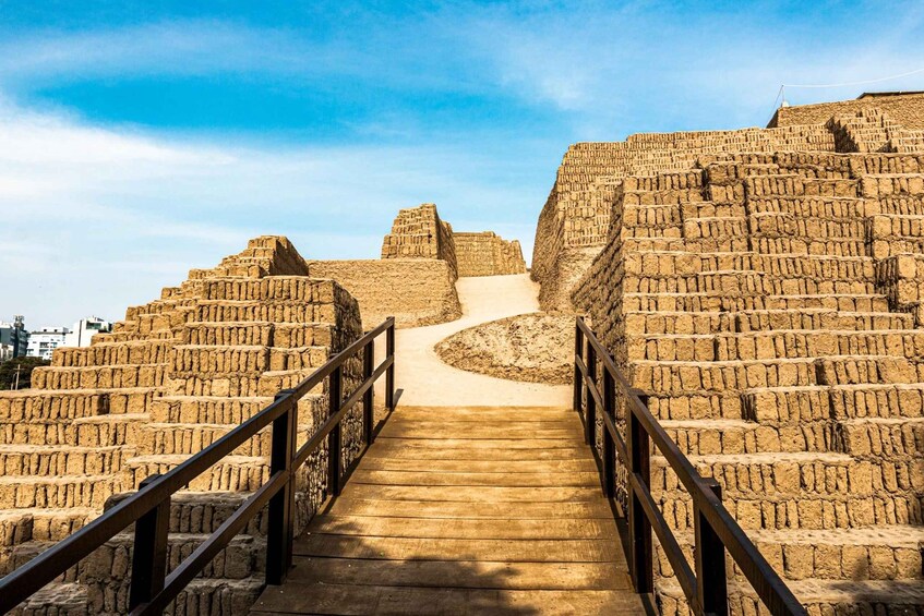 A stone staircase leading up to a pyramid structure. 3
