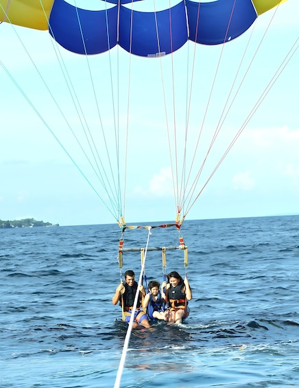 A group of people parasailing over the ocean. 3