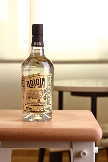 A bottle of Boigin Distilled Gin on a wooden surface. 4