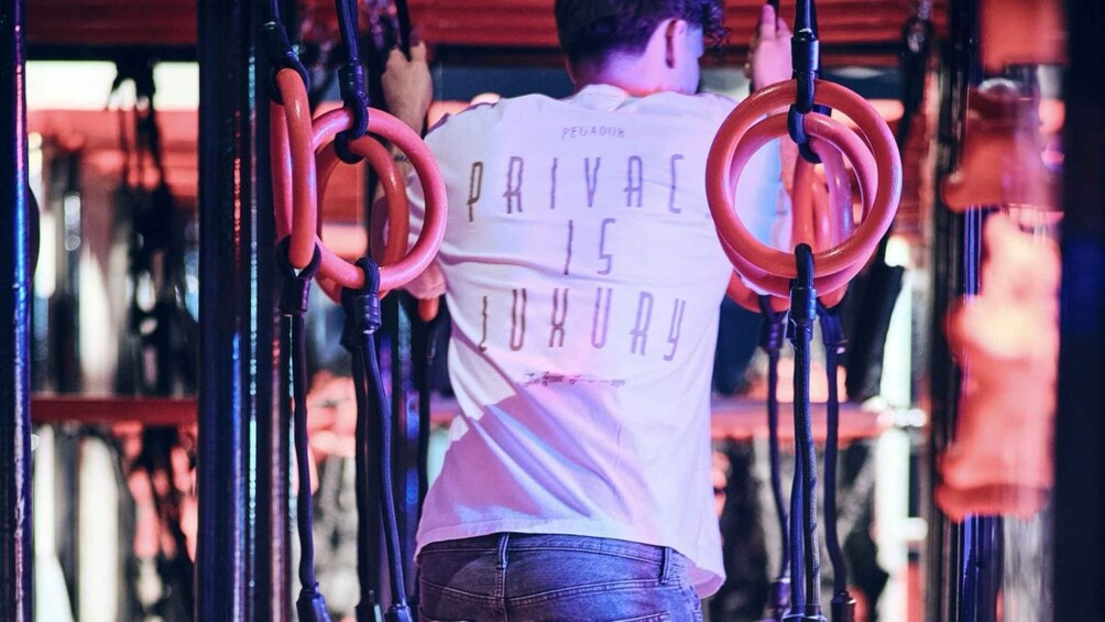 A person performing gymnastic rings exercise. 2