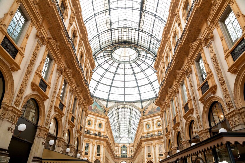 An ornate interior with a glass dome ceiling and detailed architectural elements. 3