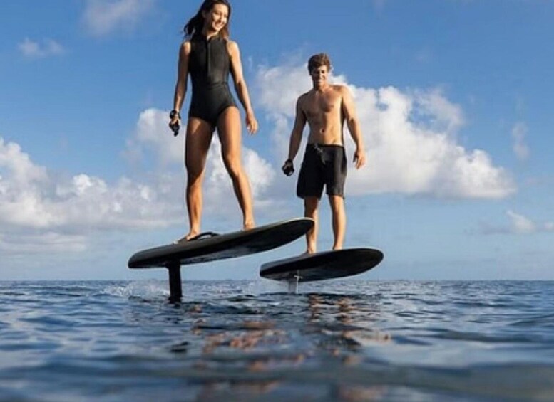 Two people on stand-up paddleboards in the ocean. 3