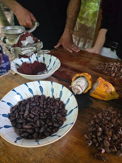 A table with various food items, including a bowl of beans, a halved pumpkin, and a pile of chocolate chips. 2