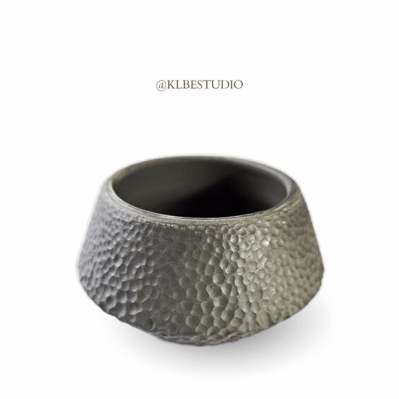 A metallic ring with a textured surface. 3