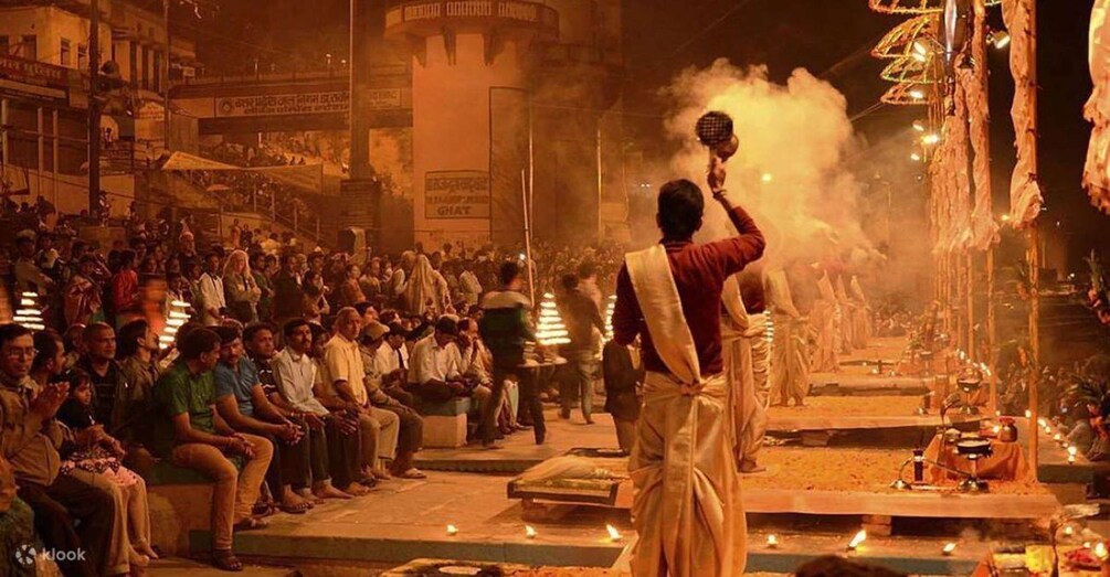 A large crowd gathered around a ceremonial event with a central figure performing a ritual. 3