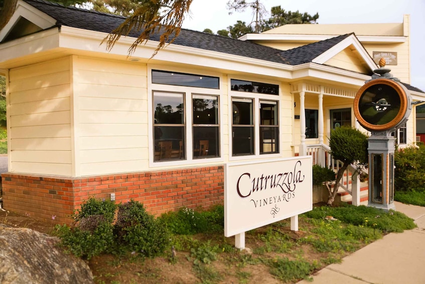 A building with a sign reading 'Cutrucola Vineyards.' 1