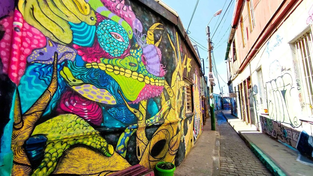 A colorful mural with various sea creatures on a building wall. 3