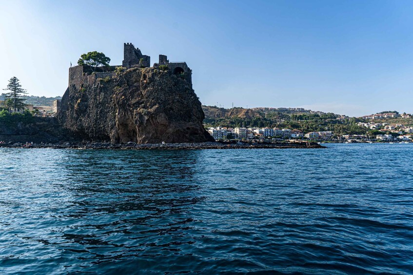 A coastal fortress on a rocky outcrop with a clear view of the surrounding town. 2