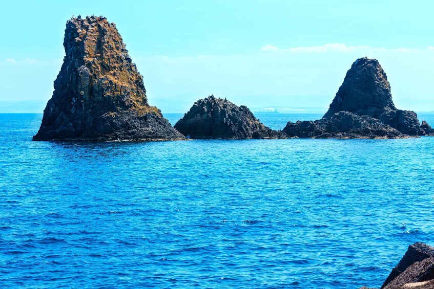 Three rocky formations in the ocean. 3
