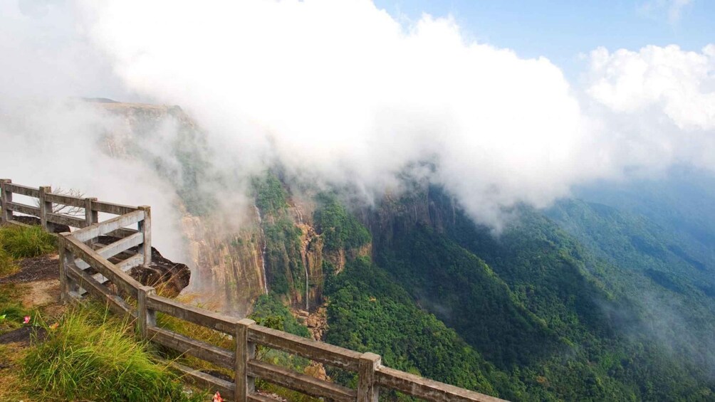 A wooden staircase leading to a misty mountain top. 1