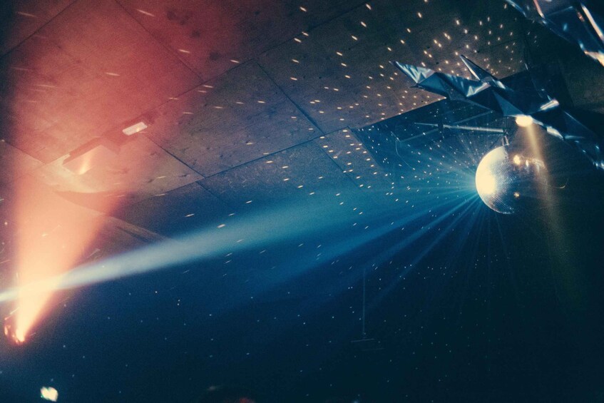 A stage with a spotlight and a disco ball. 3