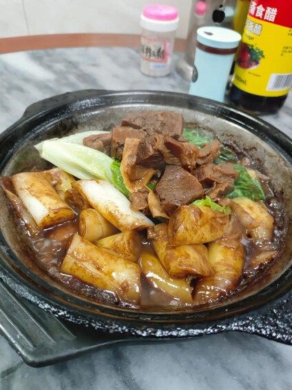 A hot pot with various meats and vegetables. 5