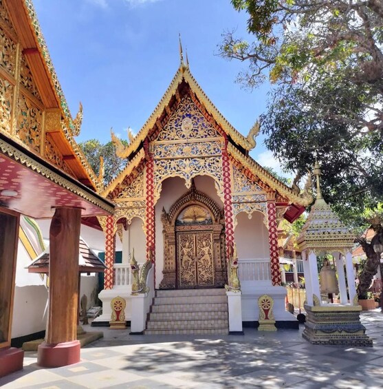 A traditional temple with ornate architecture, including a golden roof and intricate designs. 5