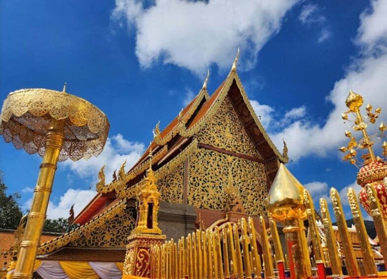A temple with ornate golden decorations and a clear blue sky. 4
