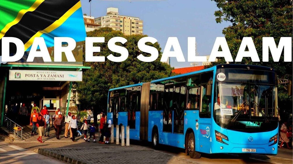 A bus station with a blue bus, people waiting, and a building with a sign reading 'POSTA YA ZAMANI'. 3