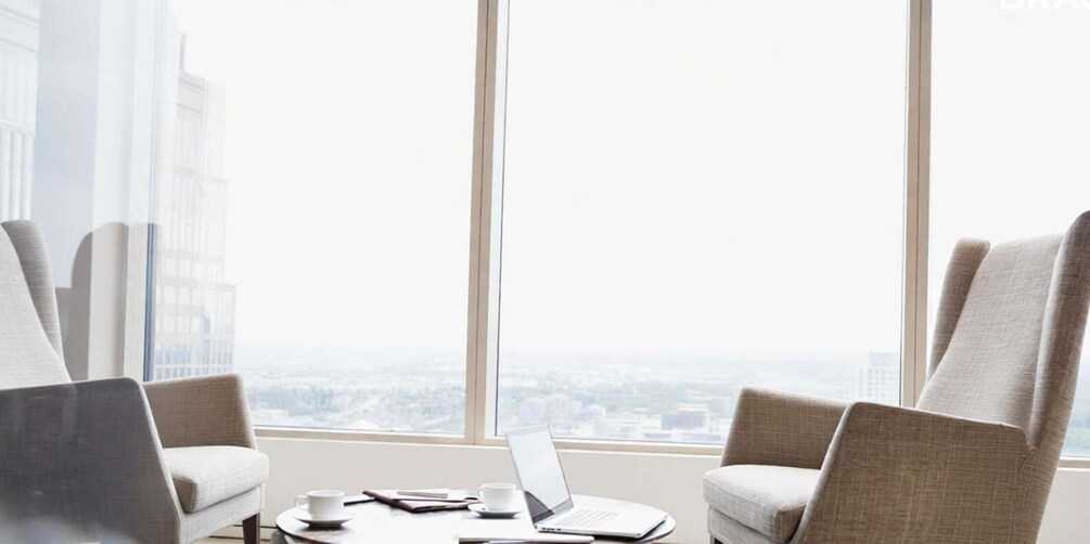 A high-rise office with a view of a cityscape through large windows. 3