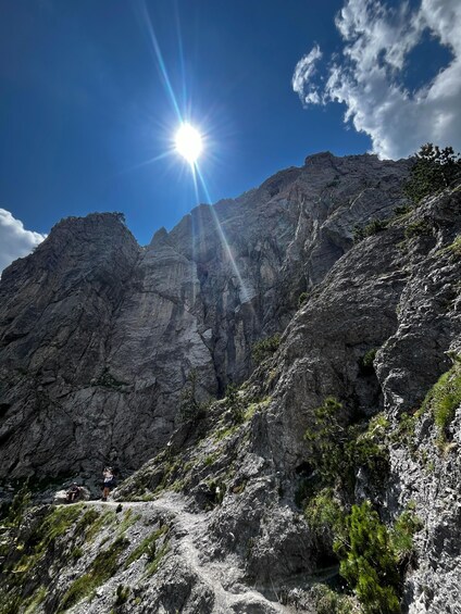A mountain landscape with rocky terrain and sparse vegetation. 5