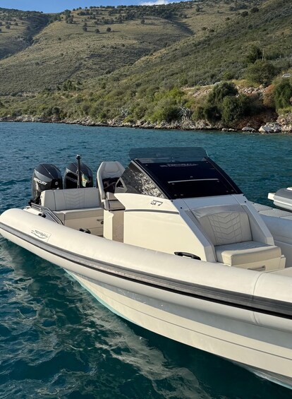 A motorboat with 'TECHNOHILL' branding on the hull, two Mercury outboard motors, and a cabin with seating. 4