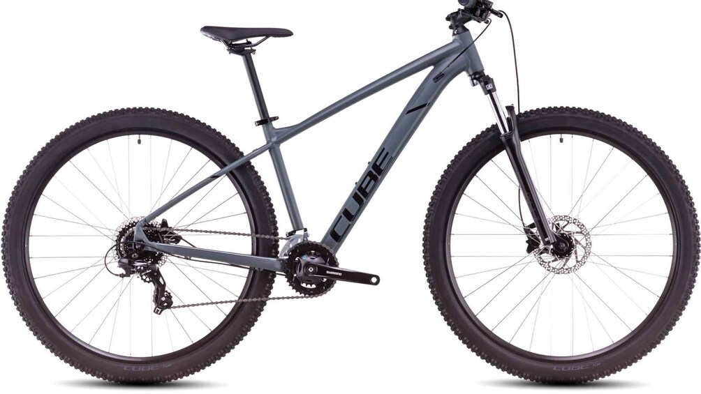A mountain bike with a front suspension fork, disc brakes, and a Shimano drivetrain. 4