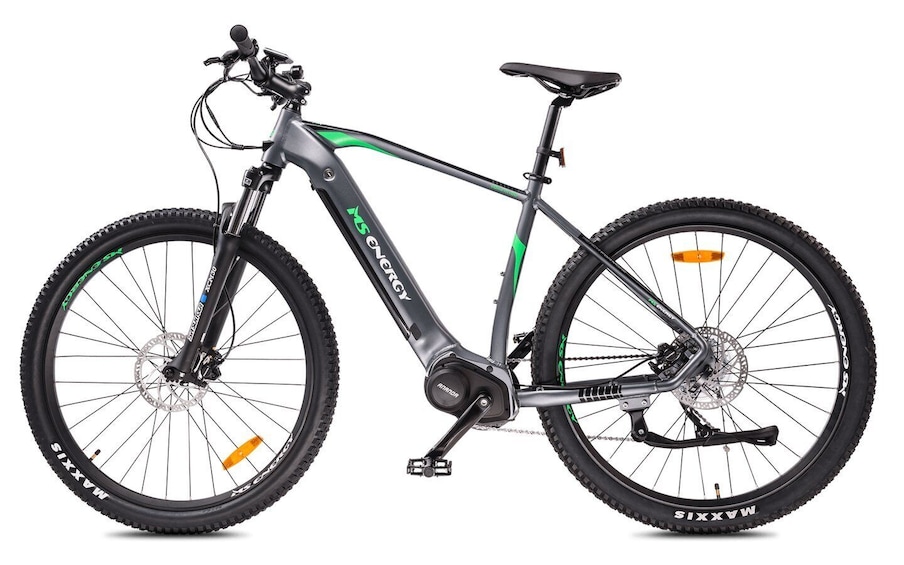 A mountain bike with a green and black frame, disc brakes, and a front suspension fork. 1