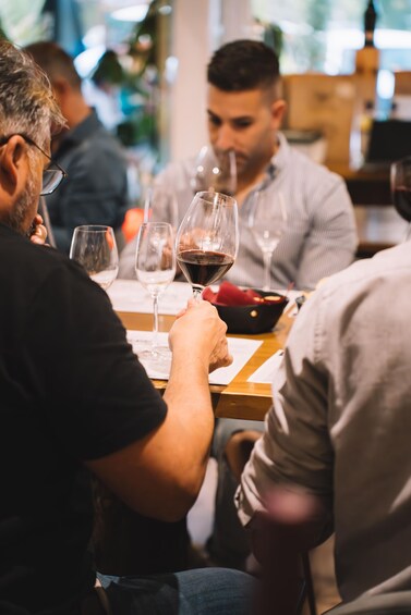 People sitting at a table with wine glasses. 1