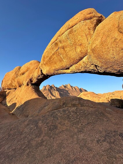 A natural rock formation with a large overhang. 2