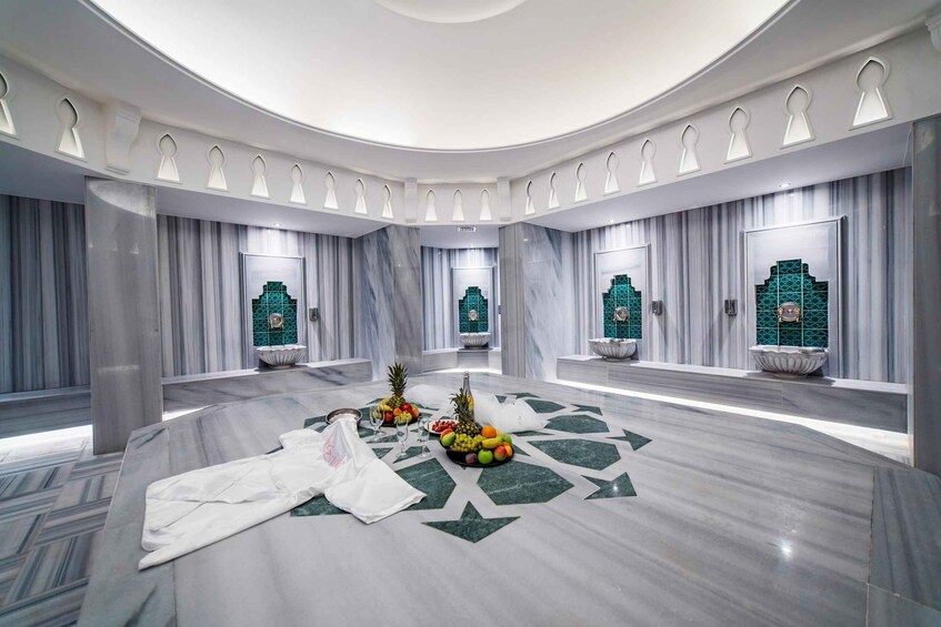 A luxurious interior with marble floors, draped curtains, and decorative lighting. 1