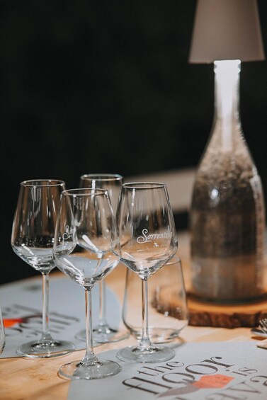 A table with wine glasses and a bottle. 3