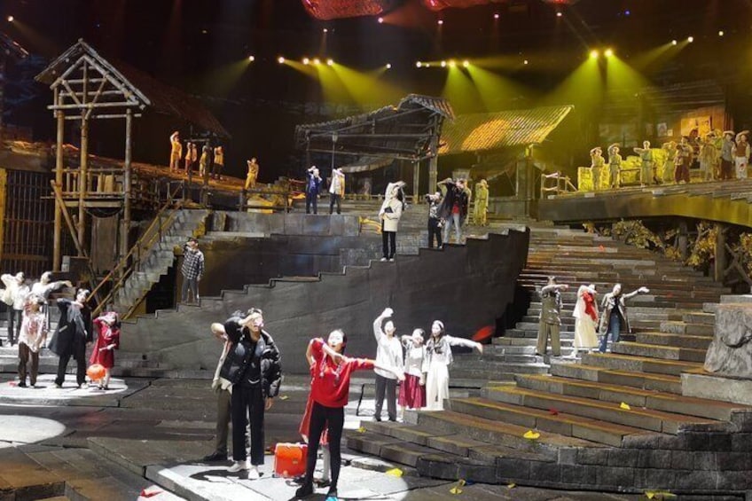 A stage with performers, a wooden structure, and steps. 4