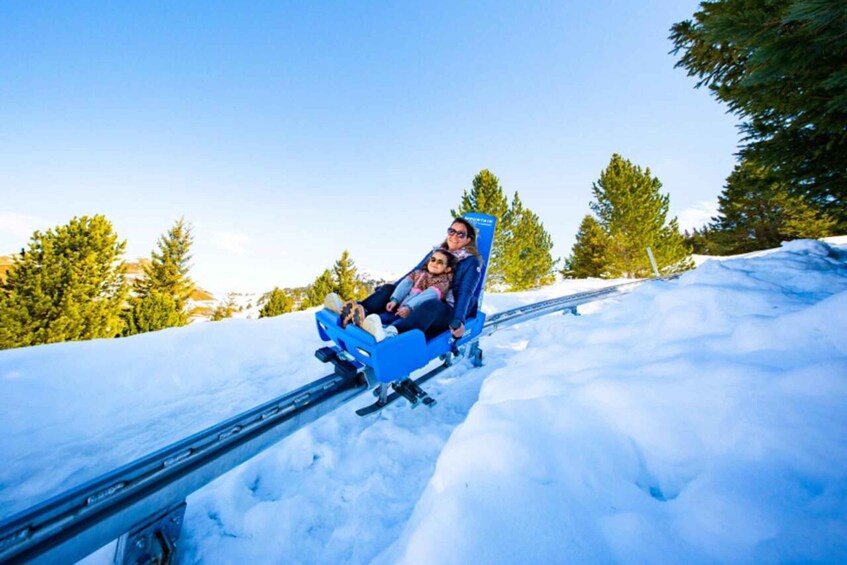 A person sledding down a snowy slope. 4