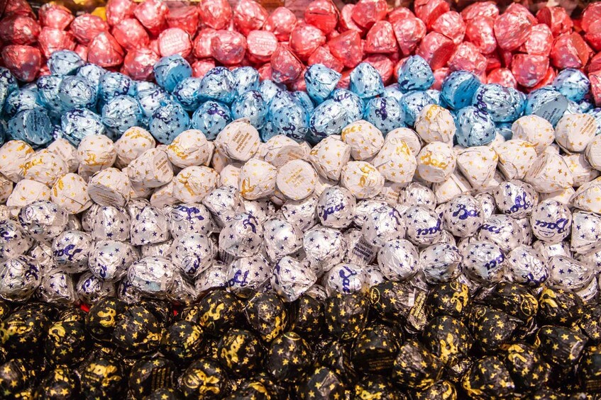 A variety of wrapped chocolates in different colors and patterns. 5