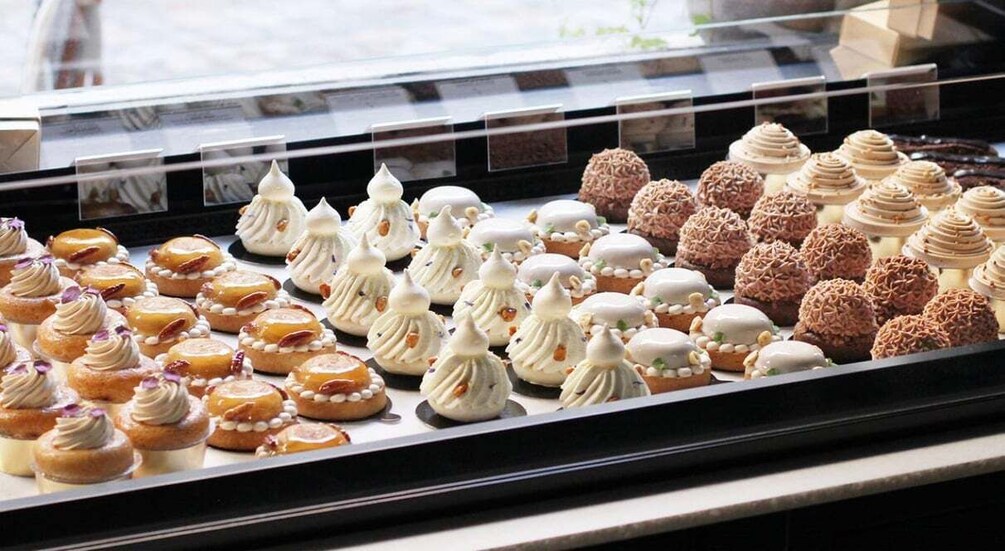 A display case with various pastries and desserts. 1