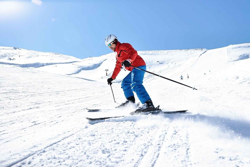 A person skiing down a snowy slope. 5