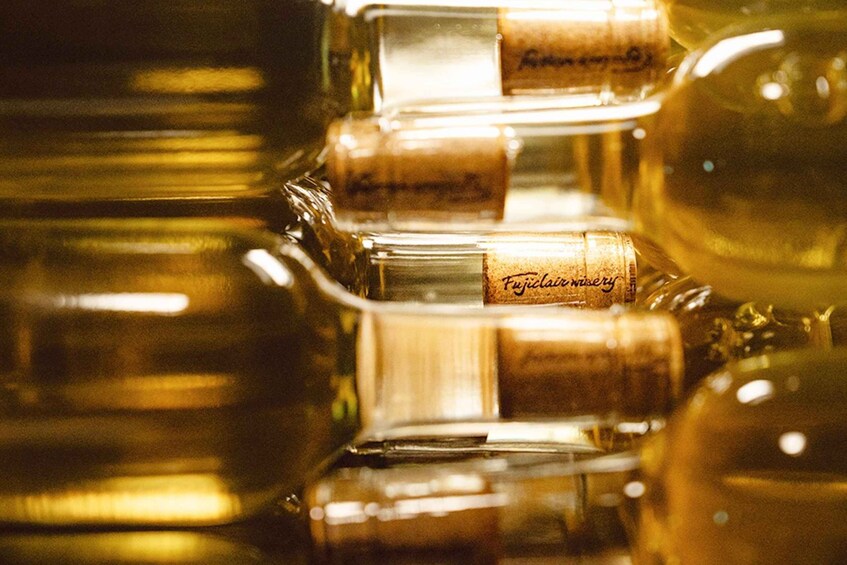 A collection of glass bottles with cork stoppers, some labeled with text. 2