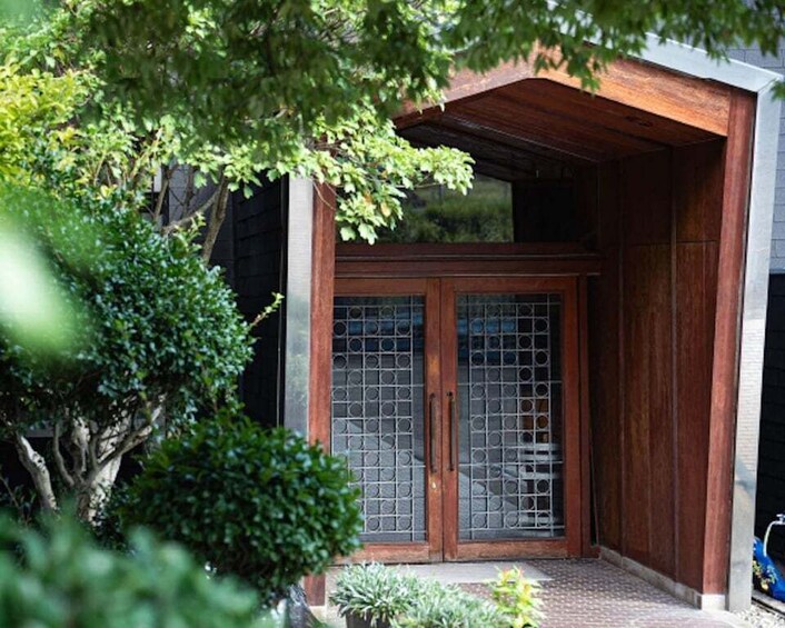 A traditional wooden entrance with a tiled floor and a metal gate. 5
