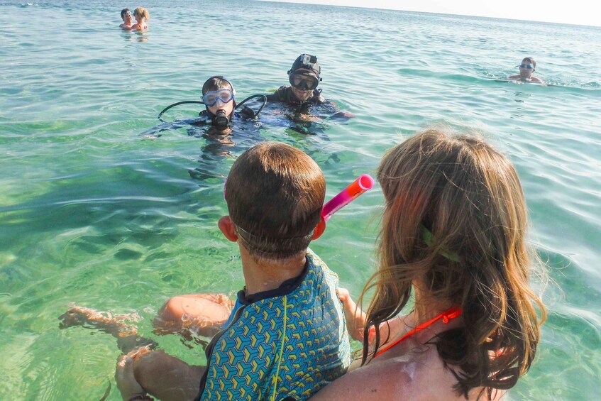 Personas haciendo snorkel en aguas azules y transparentes. 3