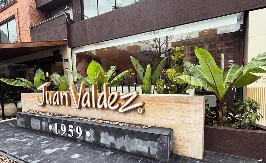 A building entrance with a sign reading 'Juan Valdez' and the year '1959' below it. 2