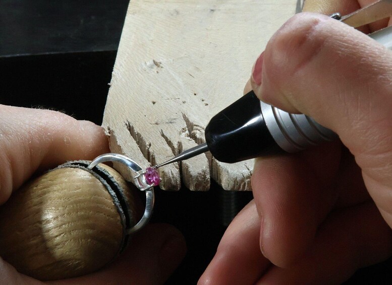 A person using a drill to work on a wooden object. 3