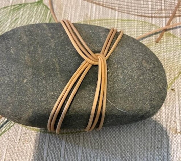 A stone tied with a rope. 2