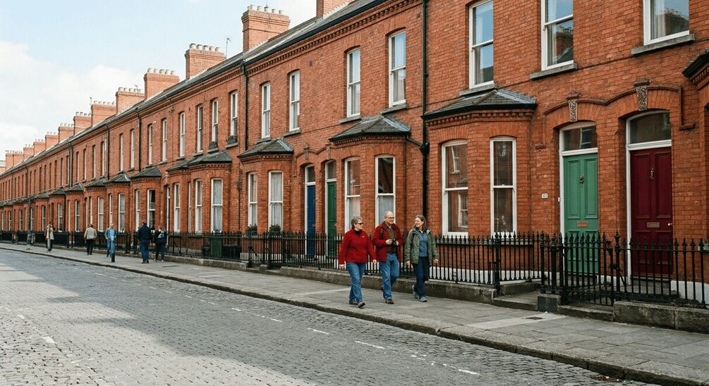 A row of red brick terraced houses with a cobblestone street. 3