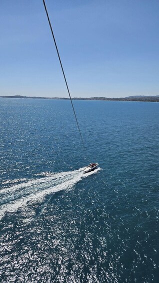 A speedboat creating a wake on a calm sea with a clear sky. 2