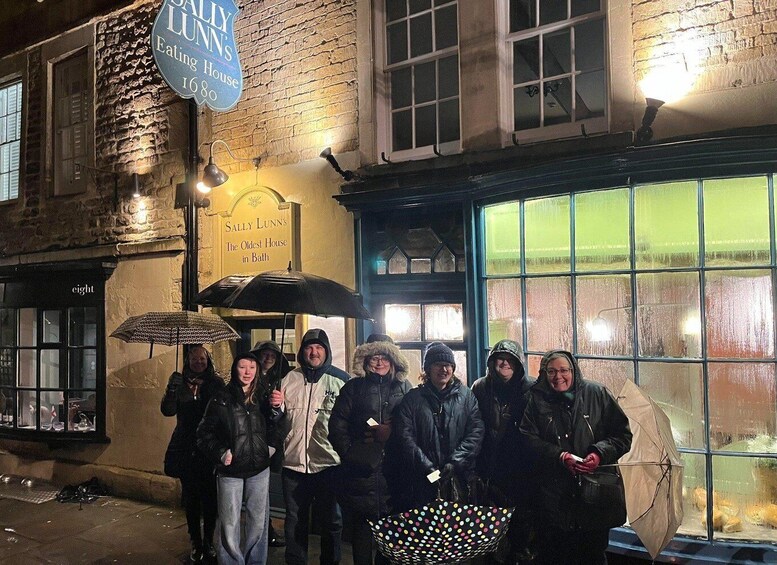 A group of people standing outside a building with a sign that reads 'Sally Lunn's Eating House.' 3