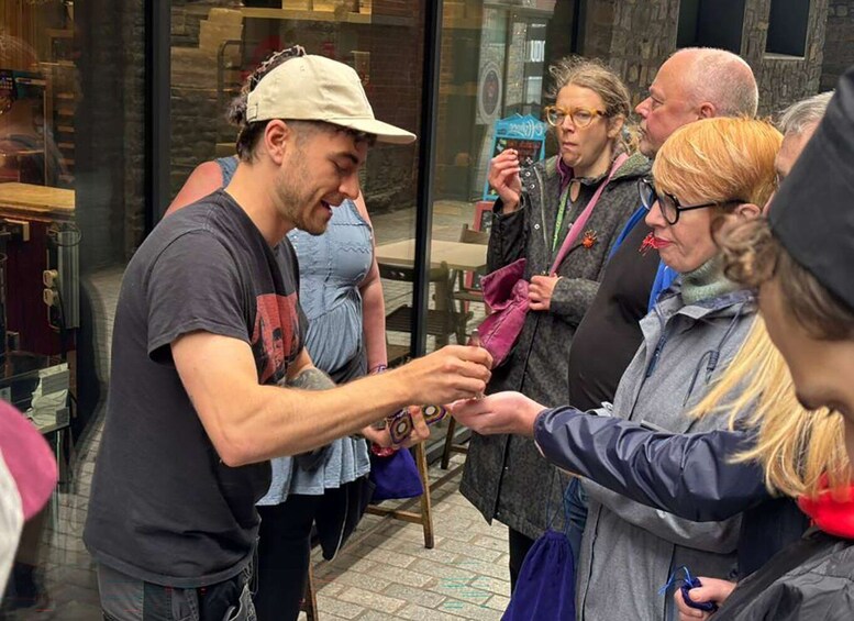 A person handing something to another person in a public setting. 5
