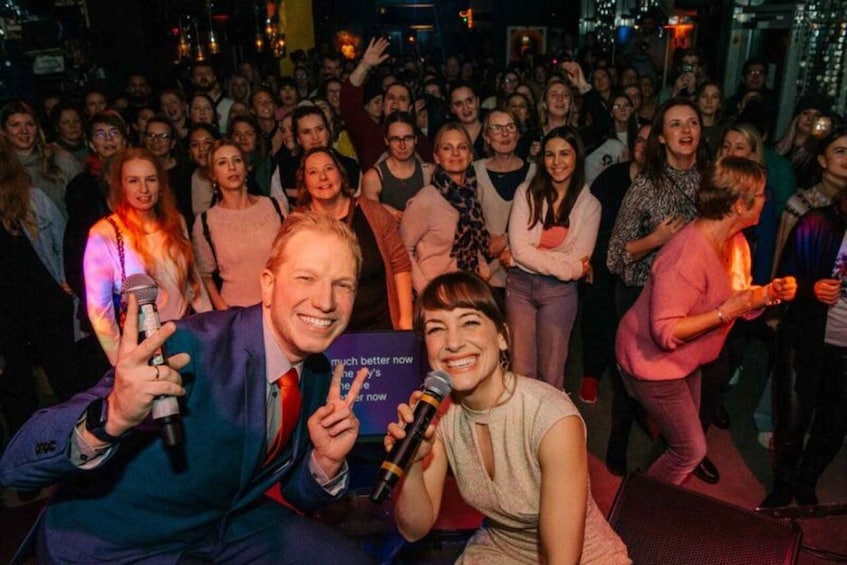 A group of people at a social event, some holding microphones. 3