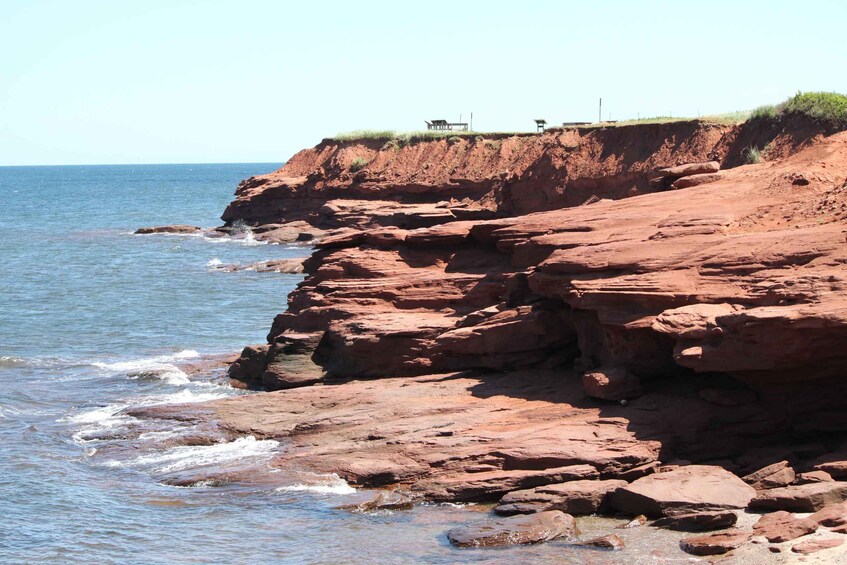 A rocky coastline with benches overlooking the sea. 1