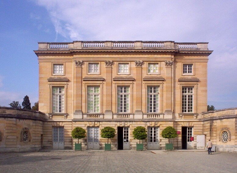 A large, classical building with a symmetrical facade, multiple windows, and a central entrance. 2