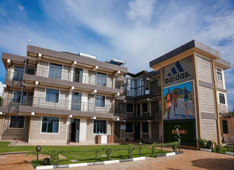 A multi-story building with a large Adidas advertisement on the side. 4