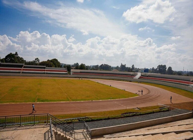 A racetrack with a grassy infield and spectator stands. 2