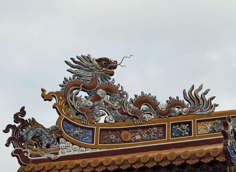 A dragon sculpture on a building's roof. 3